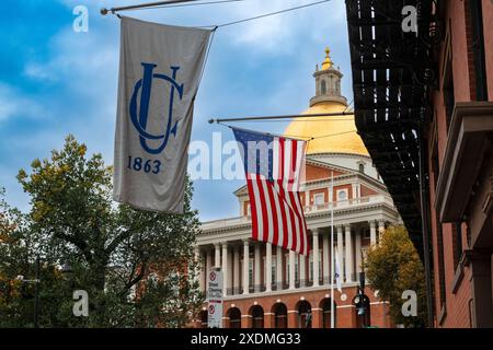 Boston, Massachusetts, USA - October 29, 2023: The United States Flag and the Union Club of Boston Flag with the Massachusetts State House in the back Stock Photo