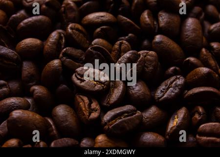 Roasted coffee beans close up background. Textured background of fresh roasted coffee beans. Stock Photo