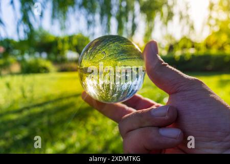 Park Illuminated by Golden Sunlight with Glass Sphere View Stock Photo