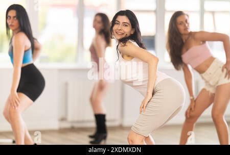 Positive slim brunette practicing jazz-funk dance in studio Stock Photo