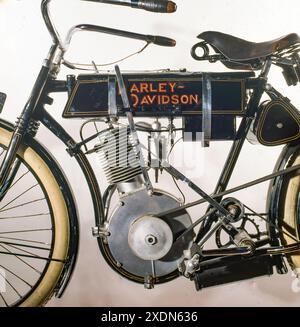 Vintage Harley-Davidson motorcycle detail showing early motorized bicycle engine, frame, fuel tank logo and mechanical components on a classic design. Stock Photo