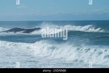 Large waves crashing over rocks on an island, big surf, salt water, Mid North coast NSW Australia Stock Photo