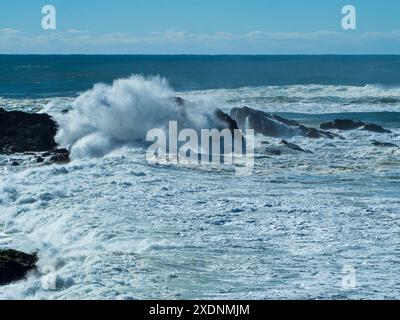 Large waves crashing over rocks on an island, big surf, salt water, Mid North coast NSW Australia Stock Photo