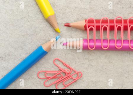 Pencils in different colors and clips on light background Stock Photo