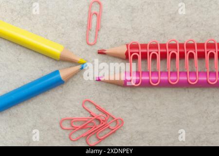 Pencils in different colors and clips on light background Stock Photo