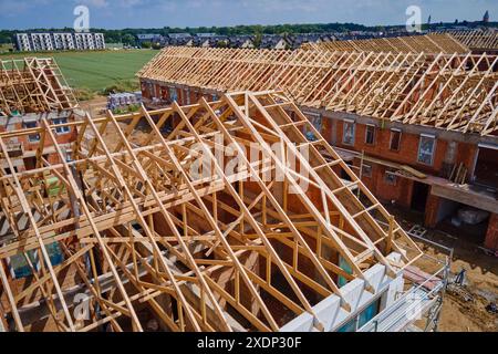 New house under construction, wooden truss system forming roof. Process of building project. Stock Photo