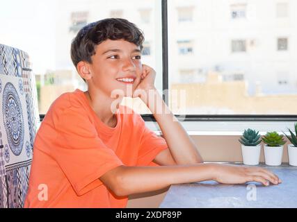preteen boy sitting smiling inside camper van Stock Photo