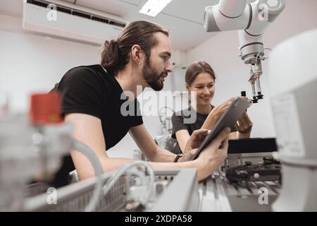 Industrial Robotics program university students learning education mechanical assembly with Robot Universal Training Platform robot arm simulation mod Stock Photo