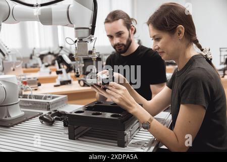 Industrial Robotics program university students learning education mechanical assembly with Robot Universal Training Platform robot arm simulation mod Stock Photo