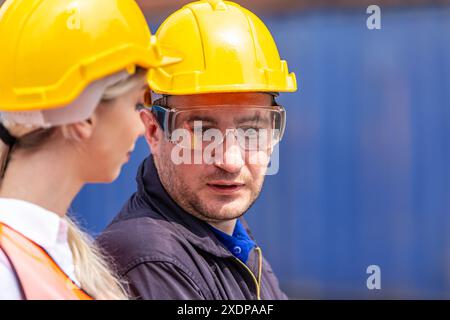 Customs worker team cooperate Talking Discussion Together in Port Cargo Shipping Container Yard. Stock Photo