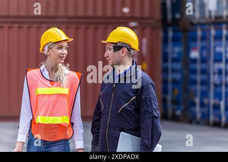 Customs worker team cooperate Talking Discussion Together in Port Cargo Shipping Container Yard. Stock Photo