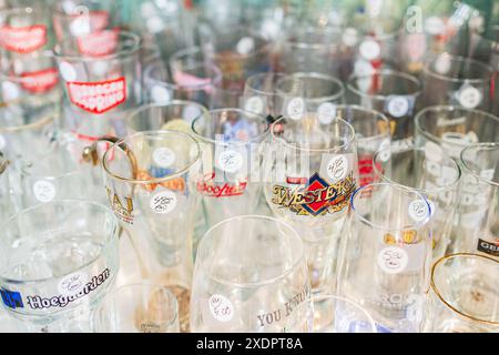 Different empty beer glassware, wine glasses, glass beakers and cups on a table. A collection of elegant crystal glasses. Set of different empty glass Stock Photo
