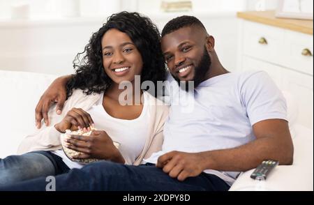 Couple Relaxing on Couch With Popcorn Stock Photo