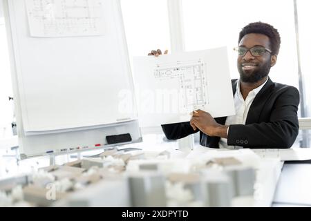 Smiling and successful dark-skinned businessman in his office Stock Photo