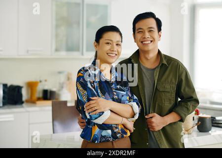 Happy Couple Standing In The Kitchen Stock Photo