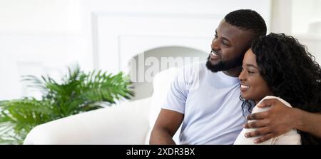 Couple Relaxing On White Couch In Home Stock Photo