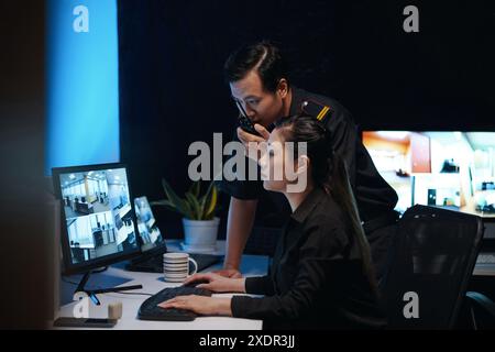 Colleagues Working In Security Room Stock Photo