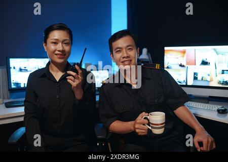 Colleagues Working In Security Post Stock Photo