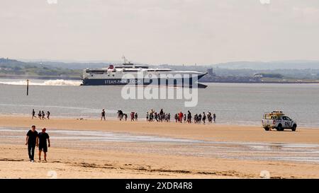 Isle of Man Steam Ferry departs from Liverpool, as people enjoy the warm weather on Crosby Beach, Merseyside. Highs of up to 31C have been forecast for this week as temperatures across the UK continue to rise. Picture date: Monday June 24, 2024. Stock Photo