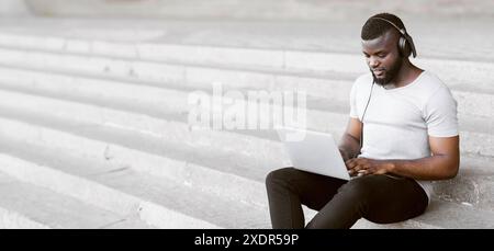 Man Using Laptop On Stairs Stock Photo