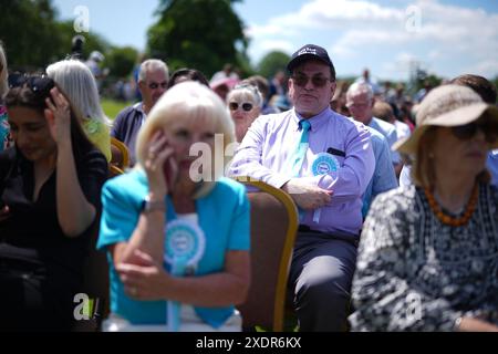 People wait for a speech by Reform UK leader Nigel Farage at the Mercure Maidstone Great Danes Hotel in Maidstone Kent. Picture date: Monday June 24, 2024. Stock Photo