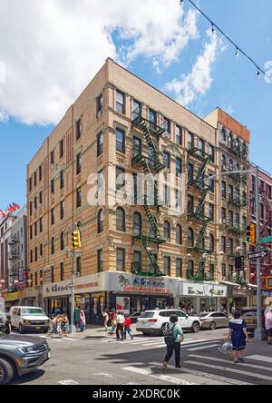 NYC Chinatown: A renovated six-story walk-up apartment building at the corner of Mott and Bayard Streets; brick parapet subs for original cornice. Stock Photo