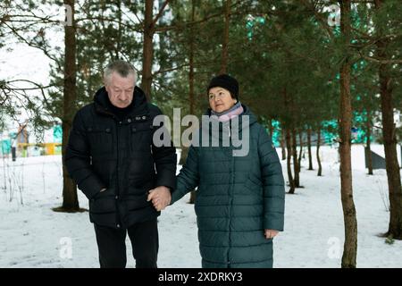 Cute retired couple going for a walk and holding hands together Stock Photo