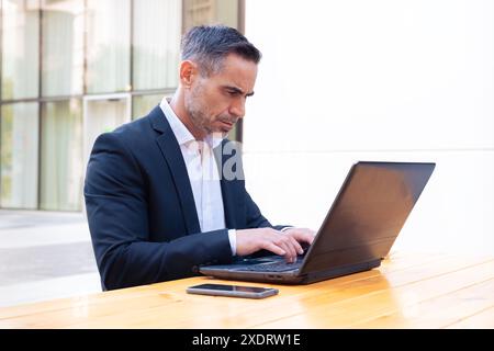 Businessman working on his laptop outdoors. Stock Photo