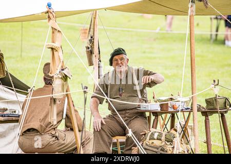 BROADCHALKE, WILTSHIRE, UK, 24th June, 2024, Shot of two soldiers in ww2 vintage uniform at Chalke History Festival, the UK's leading history festival on its opening day attracting hundreds of thousands of history enthusiasts (including tens of thousands of school children during the dedicated schools festival on the first two days). Credit John Rose/Ģ����ý Live News Stock Photo