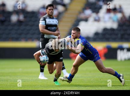 Logan Moy of Hull FC is tackled by Tristan Sailor of St Helensduring ...