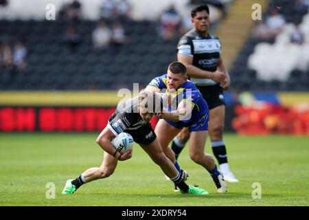 Logan Moy of Hull FC is tackled by Tristan Sailor of St Helensduring ...