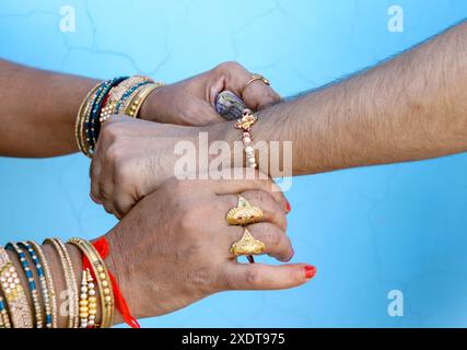 Indian festival Raksha Bandhan, Raakhi on hand, Sister tie Rakhi as symbol of intense love for her brother. Stock Photo