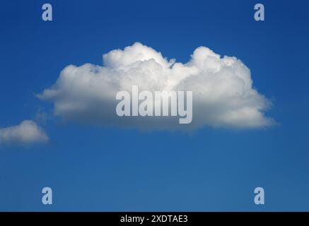 one single white cumulus cloud in the blue sky in summer Stock Photo