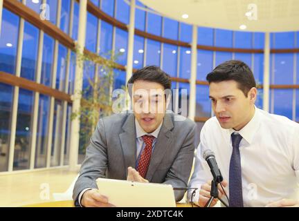 Executives with digital tablet, video conference Stock Photo