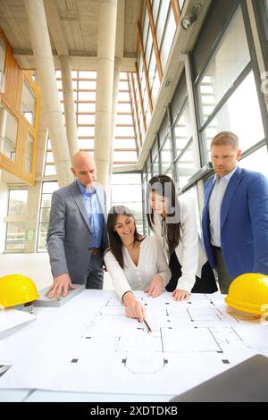 Architects looking at blueprints Stock Photo
