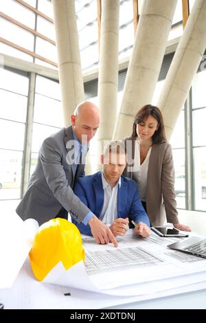 Architects looking at blueprints Stock Photo
