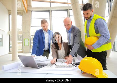 Architects looking at blueprints Stock Photo