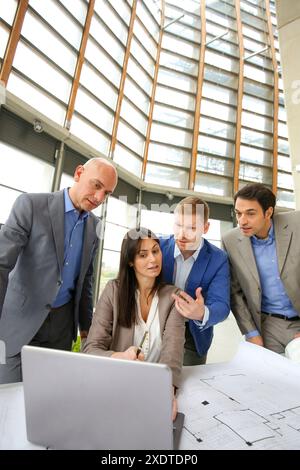 Architects looking at blueprints Stock Photo