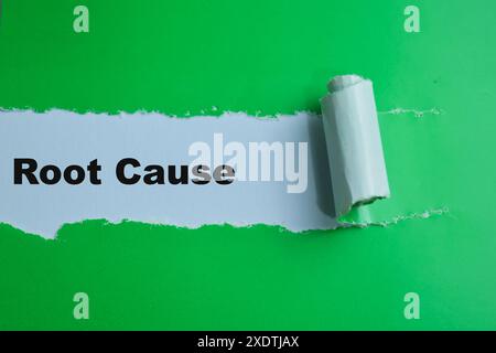 Concept of Root Cause Text written in torn paper. Stock Photo