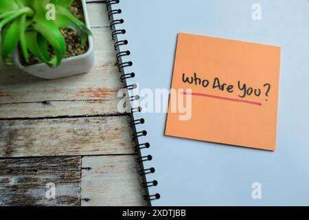 Concept of Who Are You? write on sticky notes isolated on Wooden Table. Stock Photo