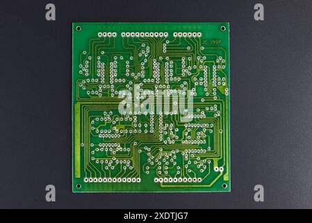 Green electronic circuit board with semiconductors on black background Stock Photo