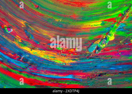 Brushstrokes and brushstrokes of acrylic paint of intense and saturated colors mixed together, perfect for backgrounds and textures forming vertical l Stock Photo