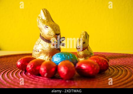 Easter egg hunting background. Various candy and chocolate Easter eggs, bunny and rabbits. Easter Celebration Concept. Chocolate Bunnies for Easter. H Stock Photo