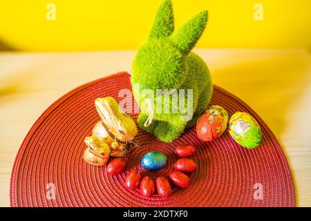 Easter egg hunting background. Various candy and chocolate Easter eggs, bunny and rabbits. Easter Celebration Concept. Chocolate Bunnies for Easter. H Stock Photo