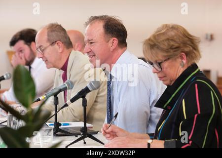 Hereford, Herefordshire, UK – Monday 24th June 2024 – Local political candidates take part in a General Election hustings event chaired by The Rt Revd Richard Jackson, Bishop of Hereford, photo shows candidate and former MP Jesse Norman ( Conservative ) centre answers a question from local residents of the Hereford and Herefordshire South constituency - Photo Steven May / Alamy Live News Stock Photo