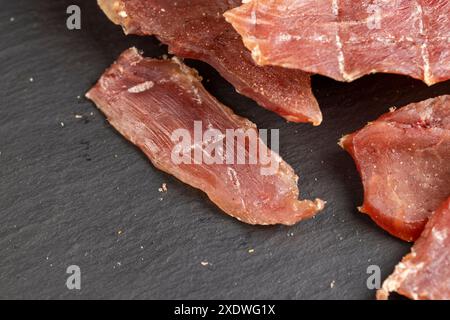 dried pork meat on the table in close-up, dried with salt and spices pork Stock Photo