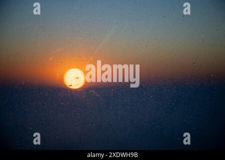 sunset through a raining window, Stock Photo