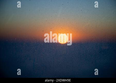 sunset through a raining window, Stock Photo