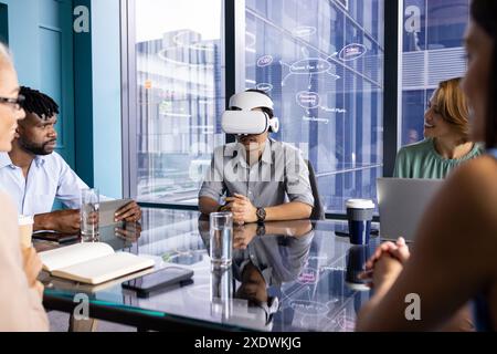 Business team in meeting, man using VR headset, colleagues discussing project ideas Stock Photo