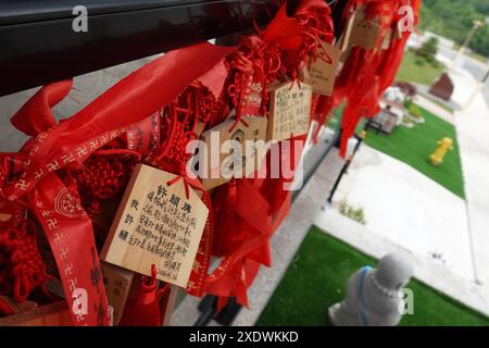 Explore a close-up view of Ema, small wooden plaques inscribed with prayers or wishes by Buddhist worshippers, at Wutai Shan Buddhist Garden in Canada Stock Photo